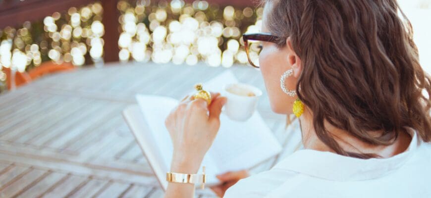 A woman sitting outside reading a book